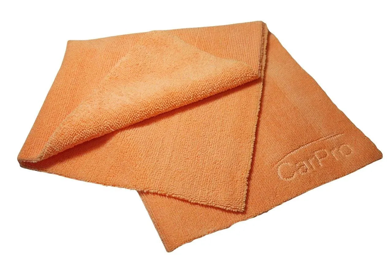 Orange CarPro microfiber towel folded, embossed logo, textured cleaning cloth