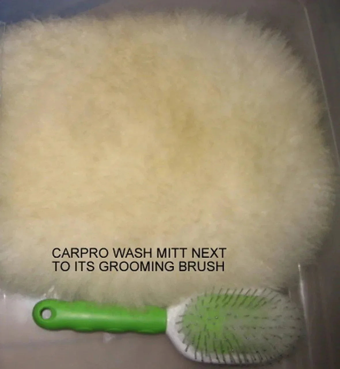 CarPro Merino wool wash mitt with green-handled grooming brush on gray surface