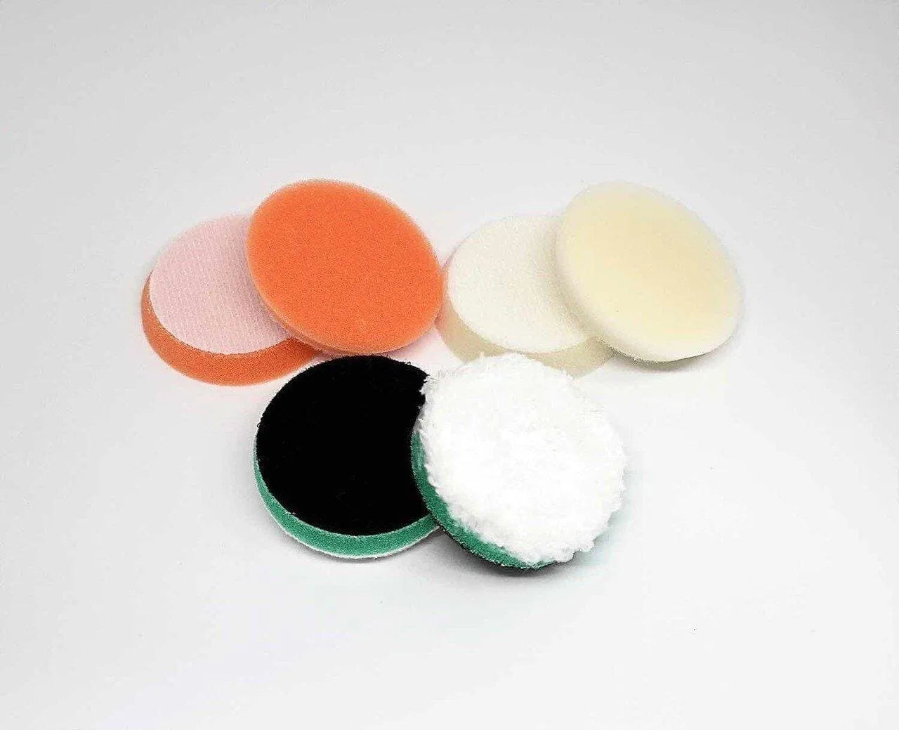 CarPro Nano polish pads six-pack with various colored foam and microfiber surfaces on white background