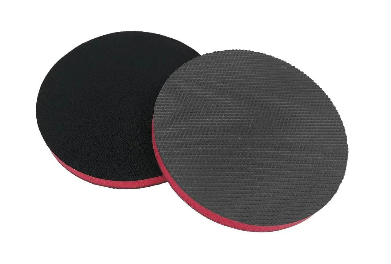 Two circular CarPro Polyshave Decon sanding discs with textured black surfaces and red edges on white background
