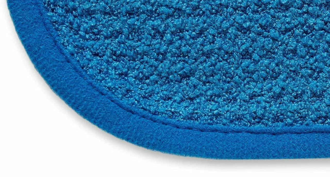 Close-up of blue microfiber cleaning cloth with textured looped surface and stitched edge
