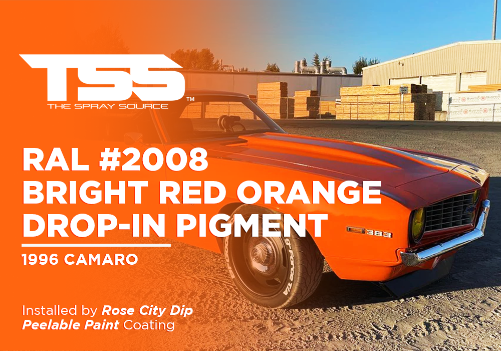 1996 orange Camaro with bright red orange paint and 383 engine badge in industrial setting
