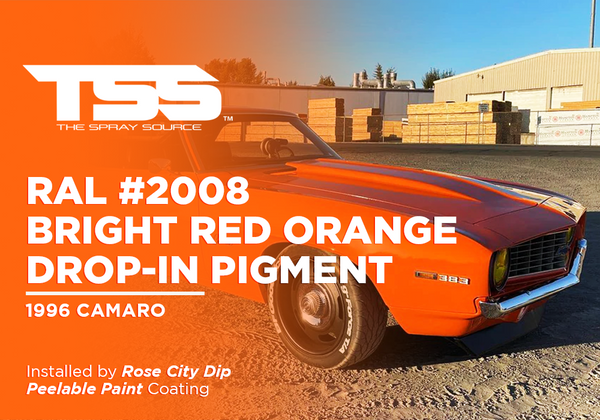 1996 orange Camaro with bright red orange paint and 383 engine badge in industrial setting