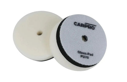Two white CarPro gloss foam polishing pads with center holes for car detailing